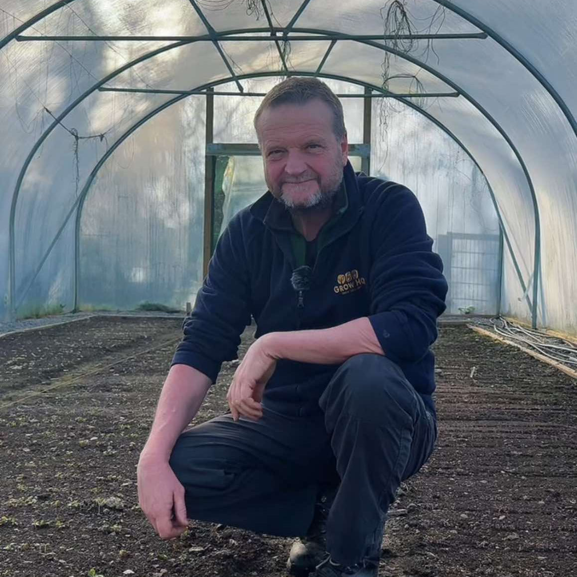 Richard in a Polytunnel ready to start growing at GROW HQ