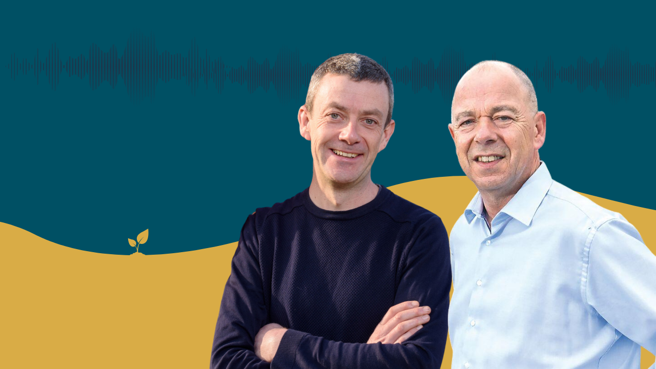Two men standing side by side against a blue and yellow background