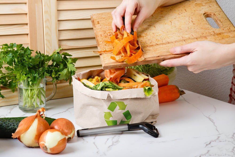 Putting veg peelings in a zero food waste bin
