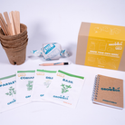Grow box kit with seed packets, pen, and packaging on a white background